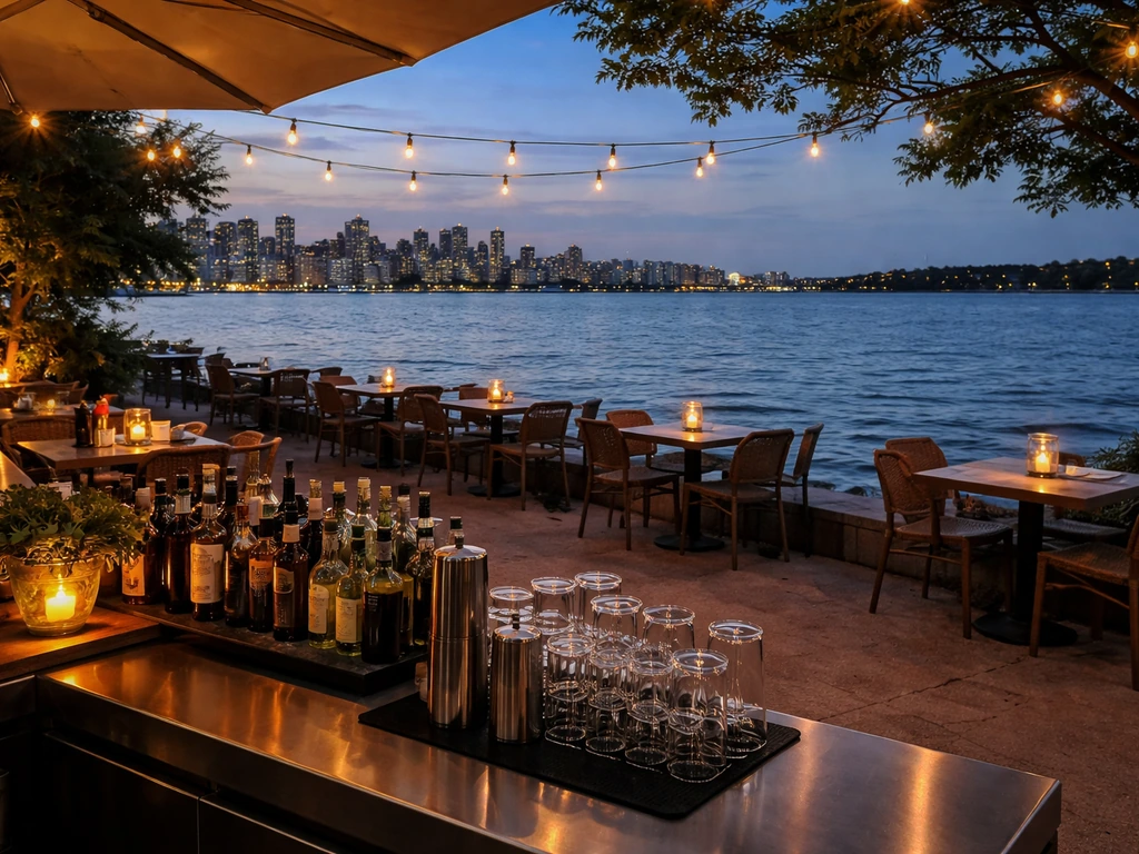 Minimal waterfront restaurant patio at dusk with visible harbor views and a cocktail bar service area.