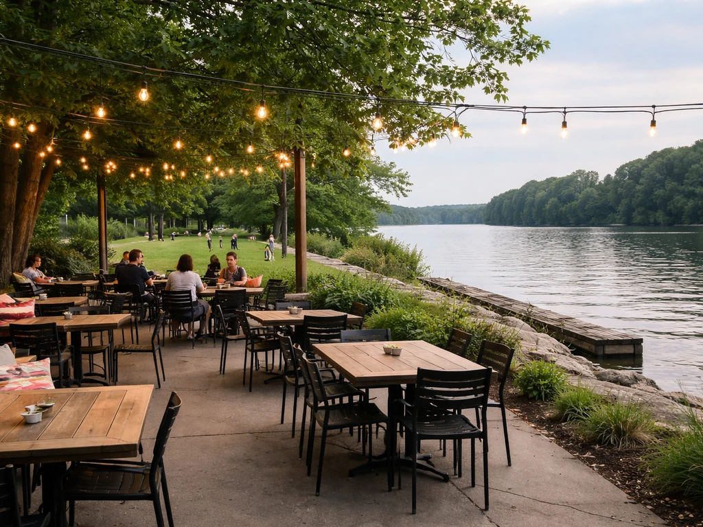 Family-friendly riverfront patio at Merwin’s Wharf with calm water, outdoor seating, and kids playing nearby