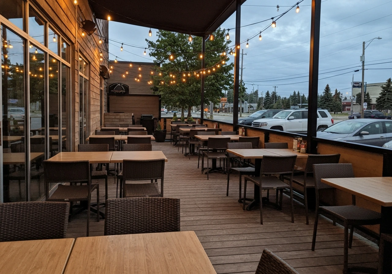 Outdoor patio seating at The Canadian Brewhouse in Sherwood Park, warm evening ambiance and group-friendly layout.
