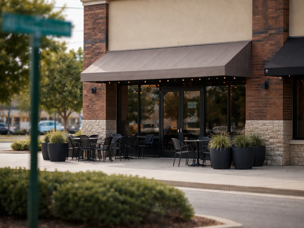 Street-level view of a grill restaurant patio entrance at a Broken Arrow address setting.