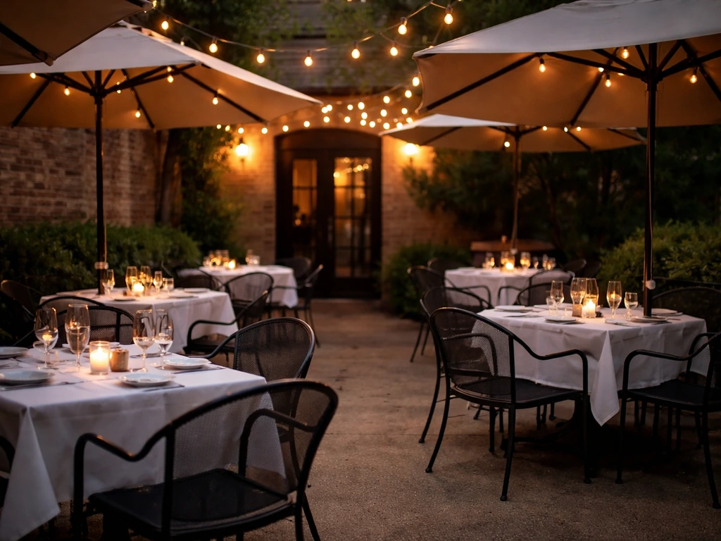 Warm evening patio dining scene with umbrellas and cozy tables outside a restaurant.